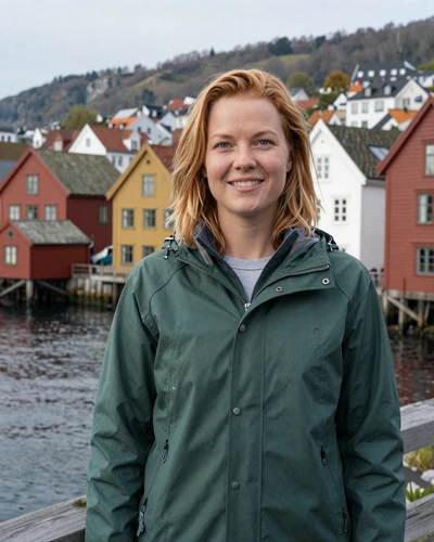 Solveig, 32, Norwegian woman in green jacket on Bergen waterfront with colorful houses