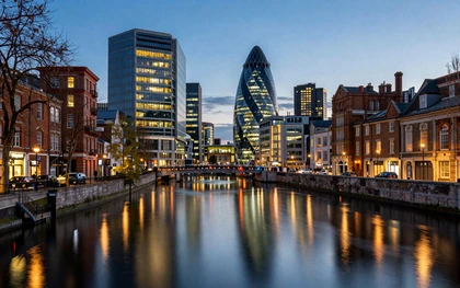 Manchester city center at dusk with canal reflections and warm lighting