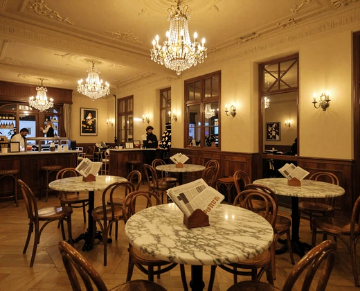 Elegant traditional Viennese coffeehouse interior with marble tables and chandeliers