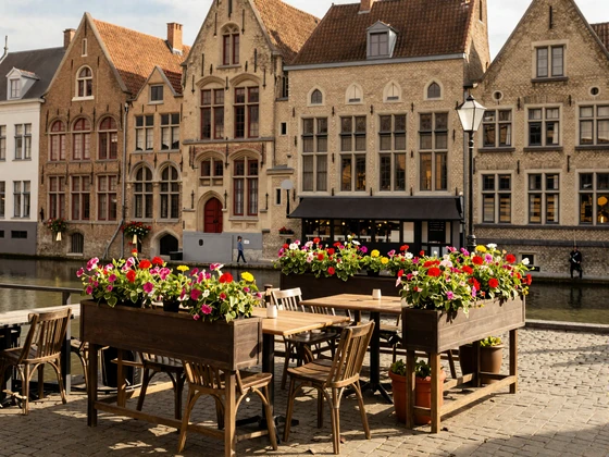 Charming Belgian cafe terrace in Bruges with medieval architecture and warm afternoon light
