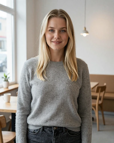 Linnea, a 29-year-old Swedish woman smiling warmly in a minimalist Stockholm cafe