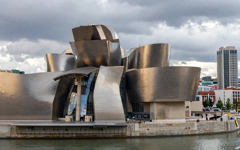 Bilbao Guggenheim Museum with metallic curves and river Nervion