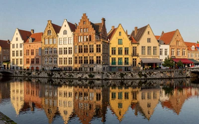 Ghent Graslei waterfront with colorful medieval buildings reflected in canal water