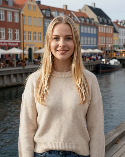 Freja a 29-year-old Danish woman with blonde hair smiling near Copenhagen canal