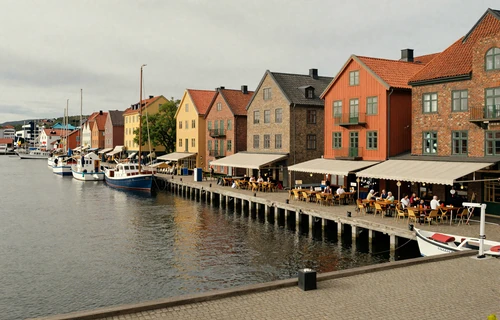 Gothenburg harbor district with waterfront restaurants and boats docked along the canal