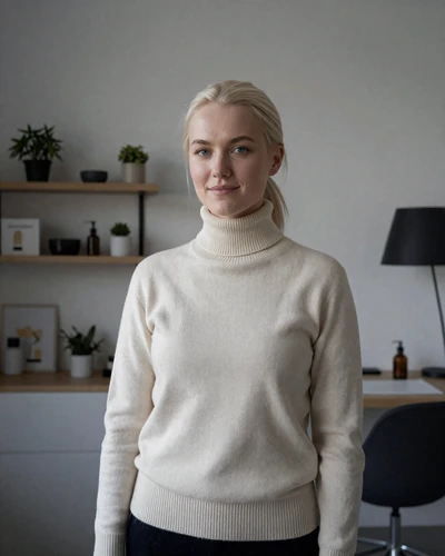 Elina, a 27-year-old Finnish woman with platinum blonde hair in a modern Helsinki design studio