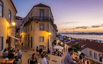Lisbon Bairro Alto neighborhood at evening with warm streetlights and outdoor cafes
