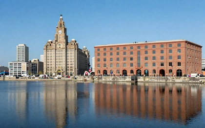 Liverpool Albert Dock waterfront with historic red brick buildings and blue sky