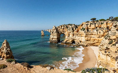 Stunning Algarve coastline near Faro with golden cliffs and turquoise Atlantic waters